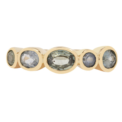 Lauren Wolf - Gold ring with five green gemstones on a white background