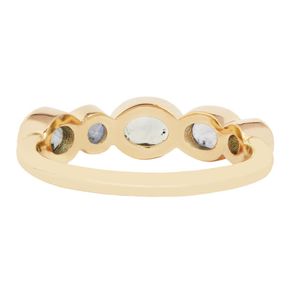 Lauren Wolf - Gold ring with embedded stones on a white background