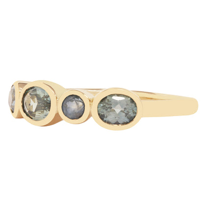 Lauren Wolf - Gold ring with multiple circular gemstones on a white background