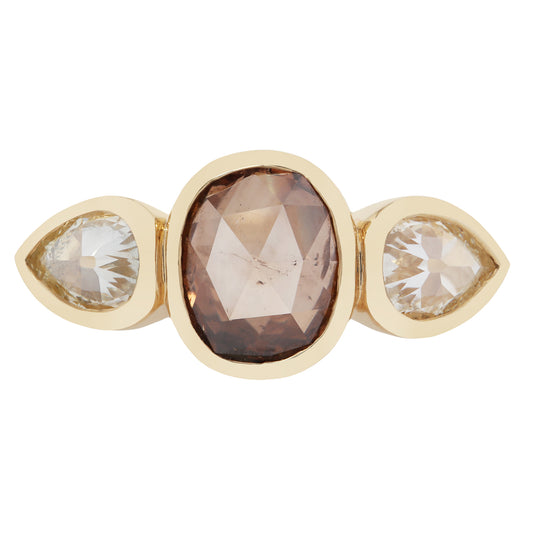 Gold ring with three gemstones on a white background