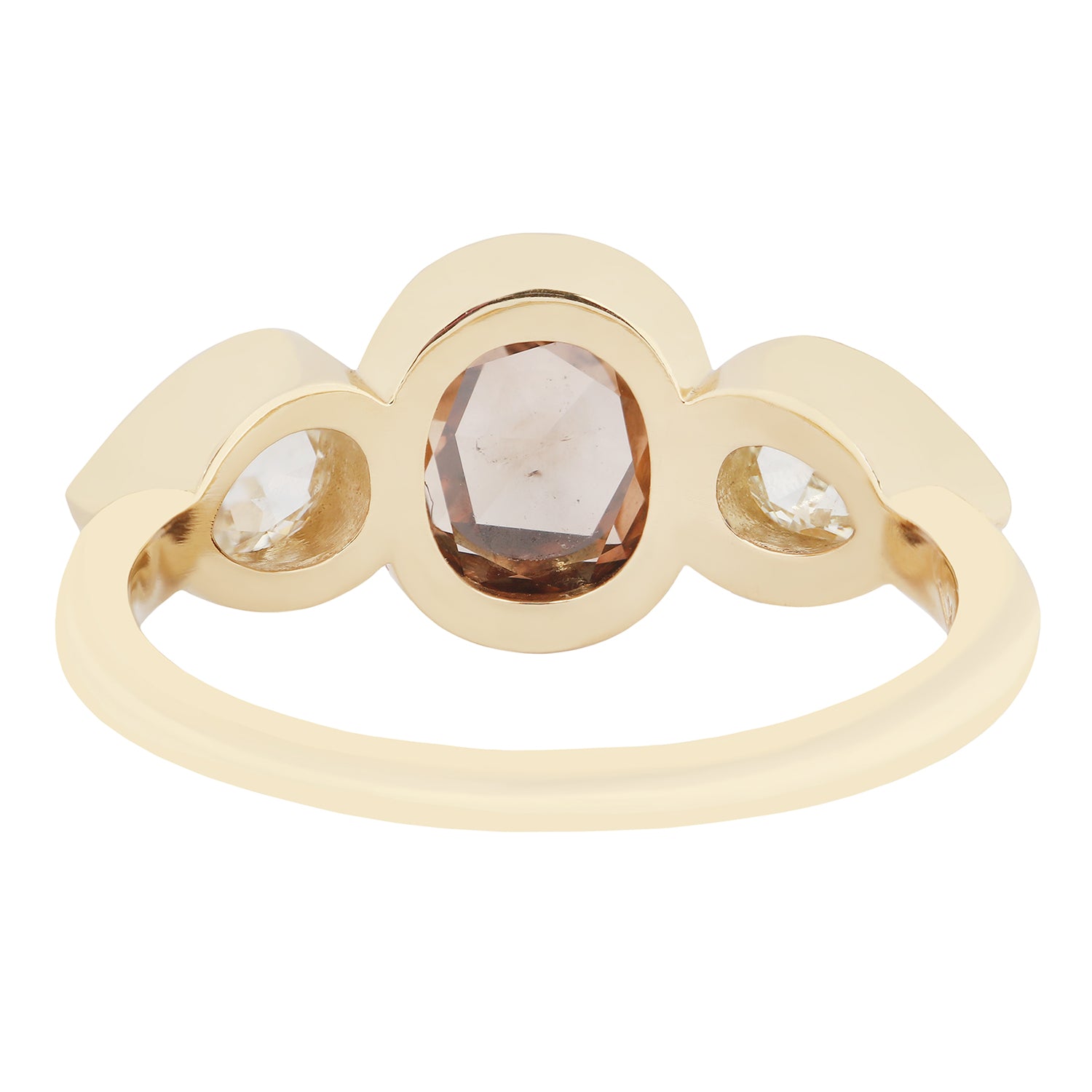 Gold ring with three gemstones on a white background
