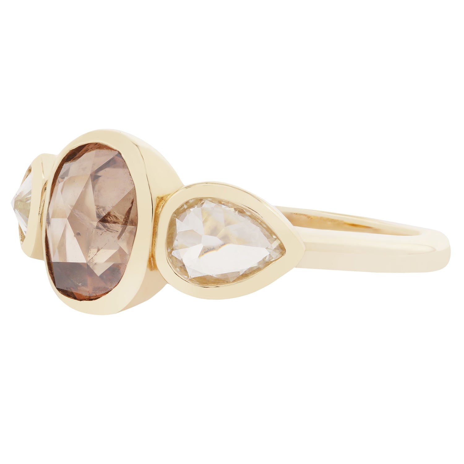 Gold ring with three gemstones on a white background
