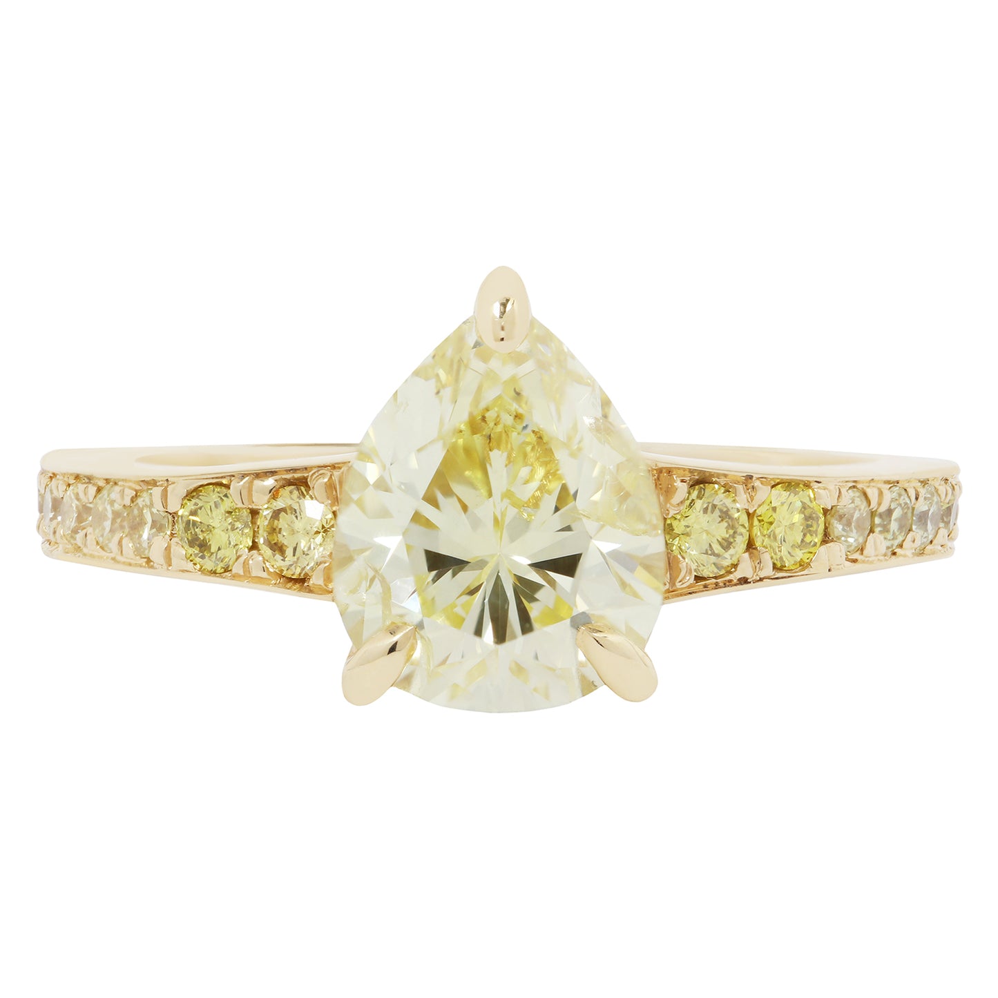 Gold ring with a large pear-shaped yellow diamond and smaller diamonds on the band against a white background