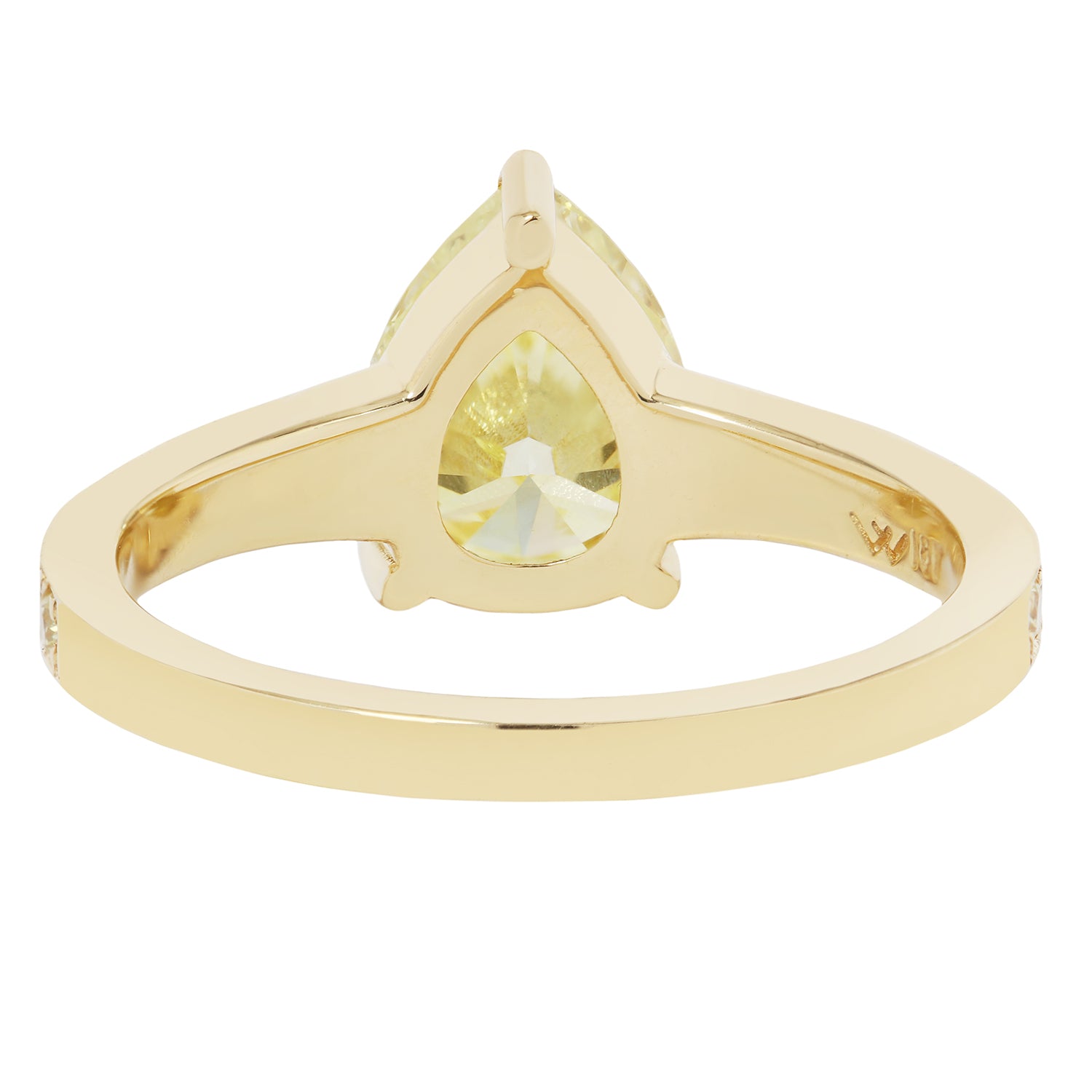 Gold ring with a yellow gemstone on a white background