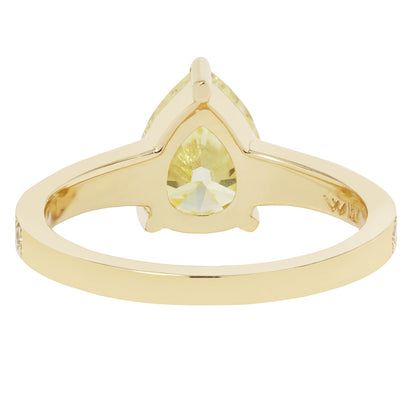 Gold ring with a yellow gemstone on a white background