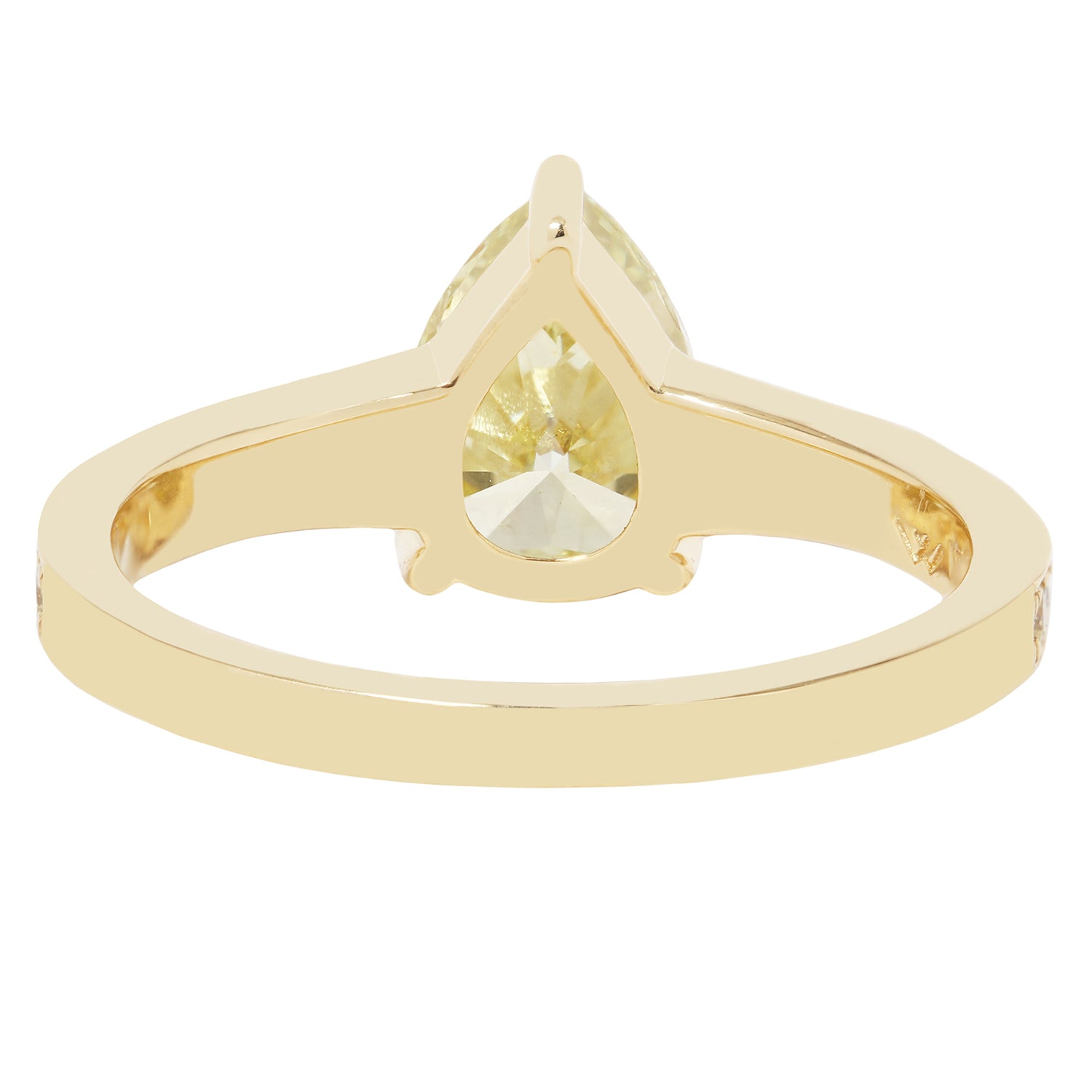 Gold ring with a pear-shaped gemstone on a white background
