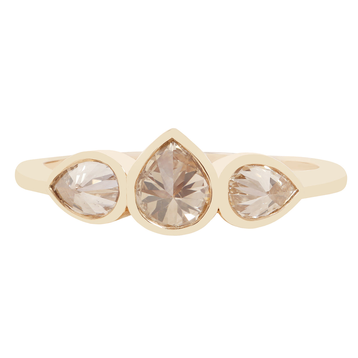 Three pear shape diamond ring in yellow gold on a white background
