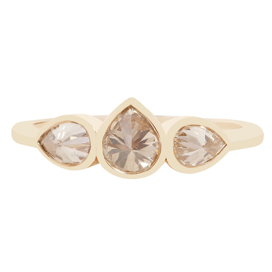 Three pear shape diamond ring in yellow gold on a white background