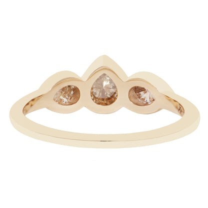 Three pear shape diamond ring in yellow gold on a white background