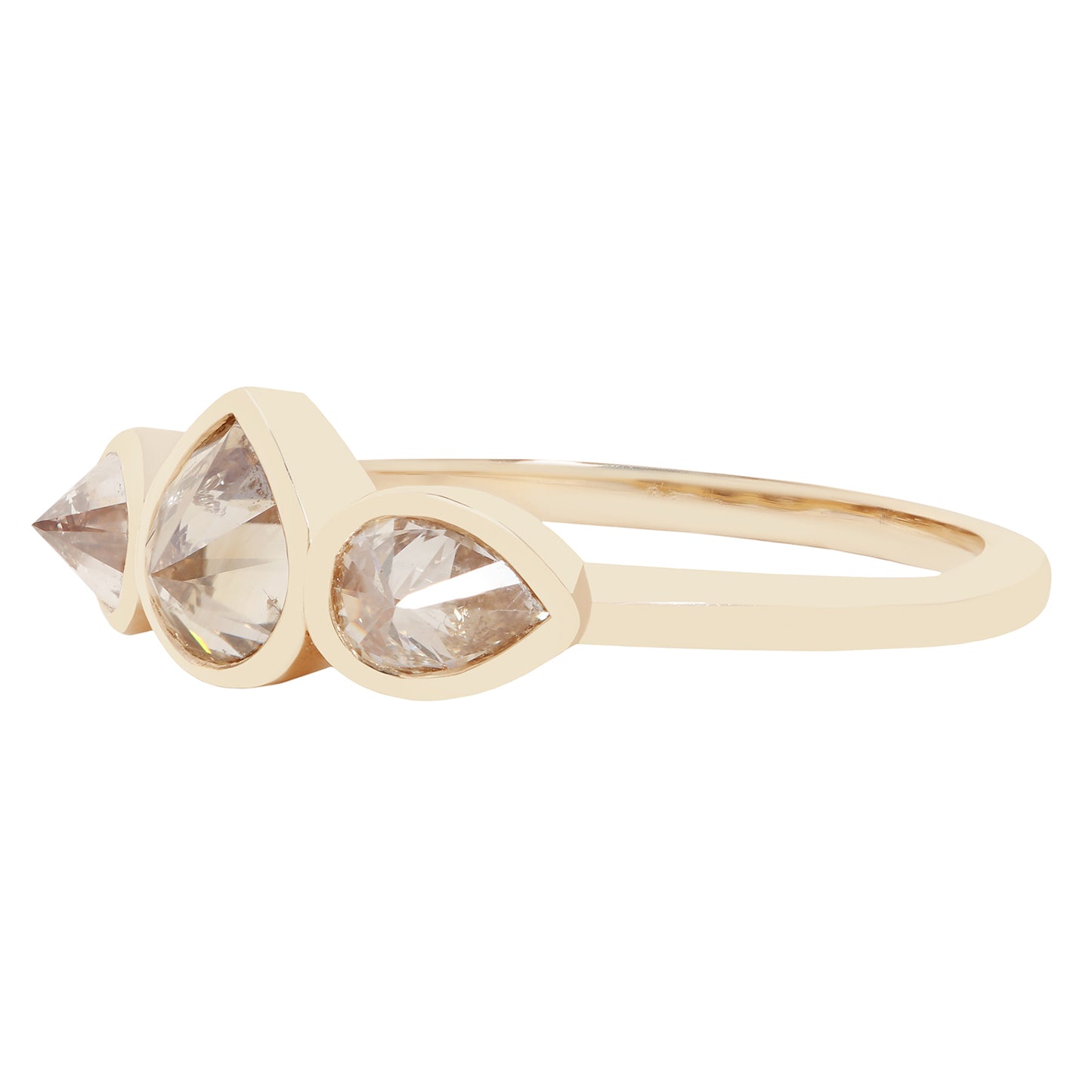 Three pear shape diamond ring in yellow gold on a white background