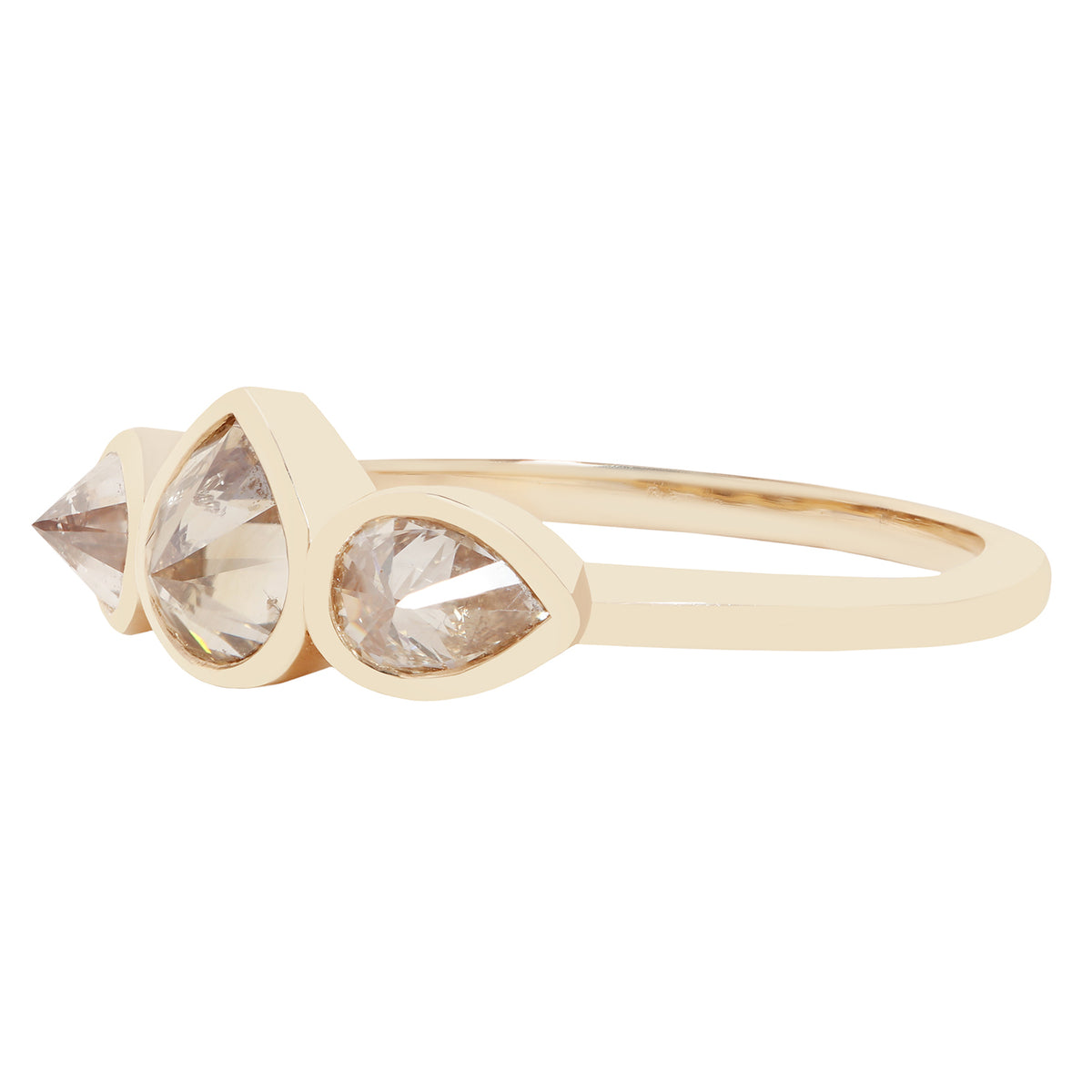 Three pear shape diamond ring in yellow gold on a white background