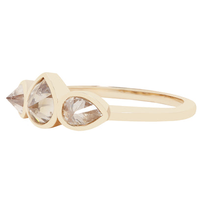 Three pear shape diamond ring in yellow gold on a white background