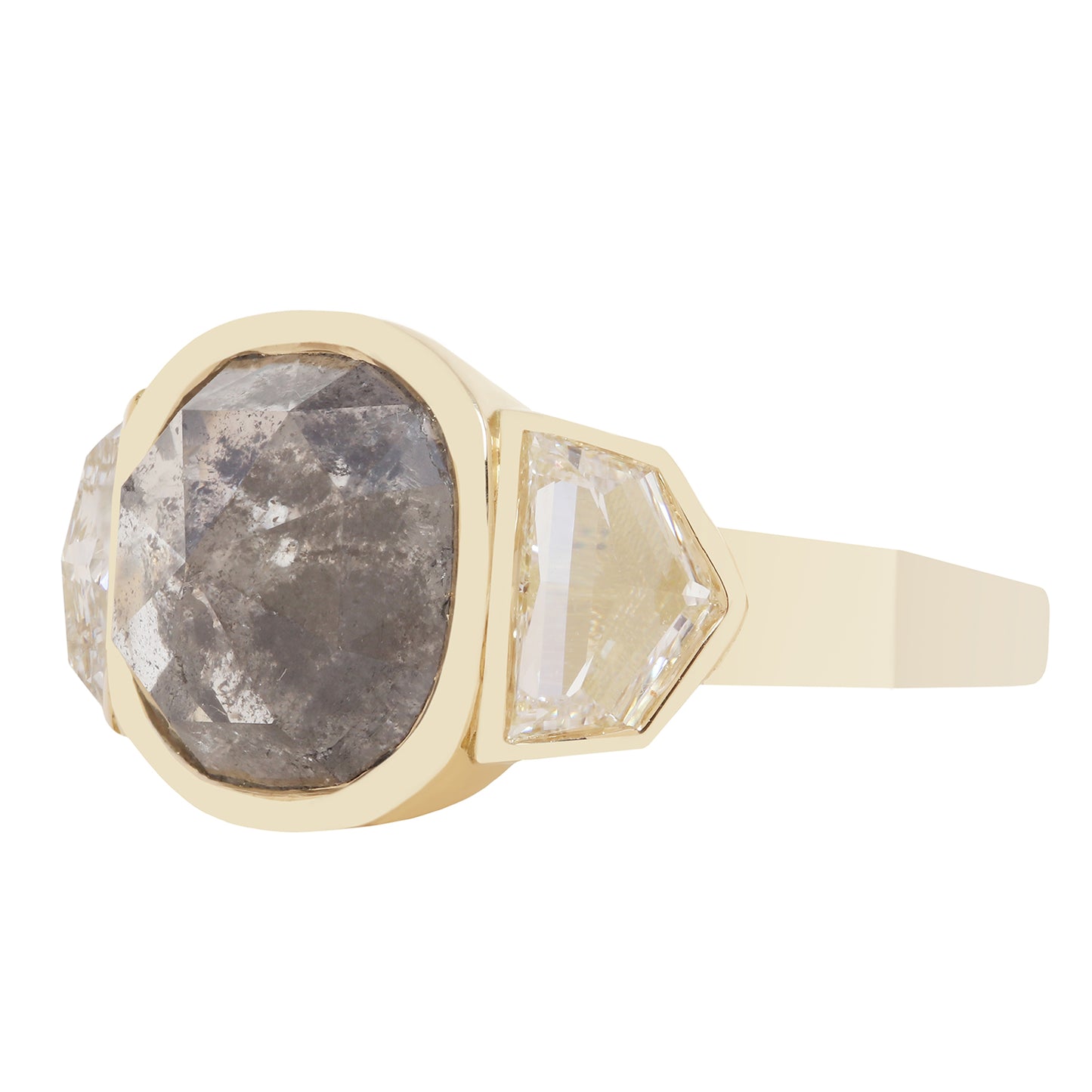 A yellow gold signet ring featuring a large, rough-cut gray diamond and a smaller, faceted clear diamond on a white background.