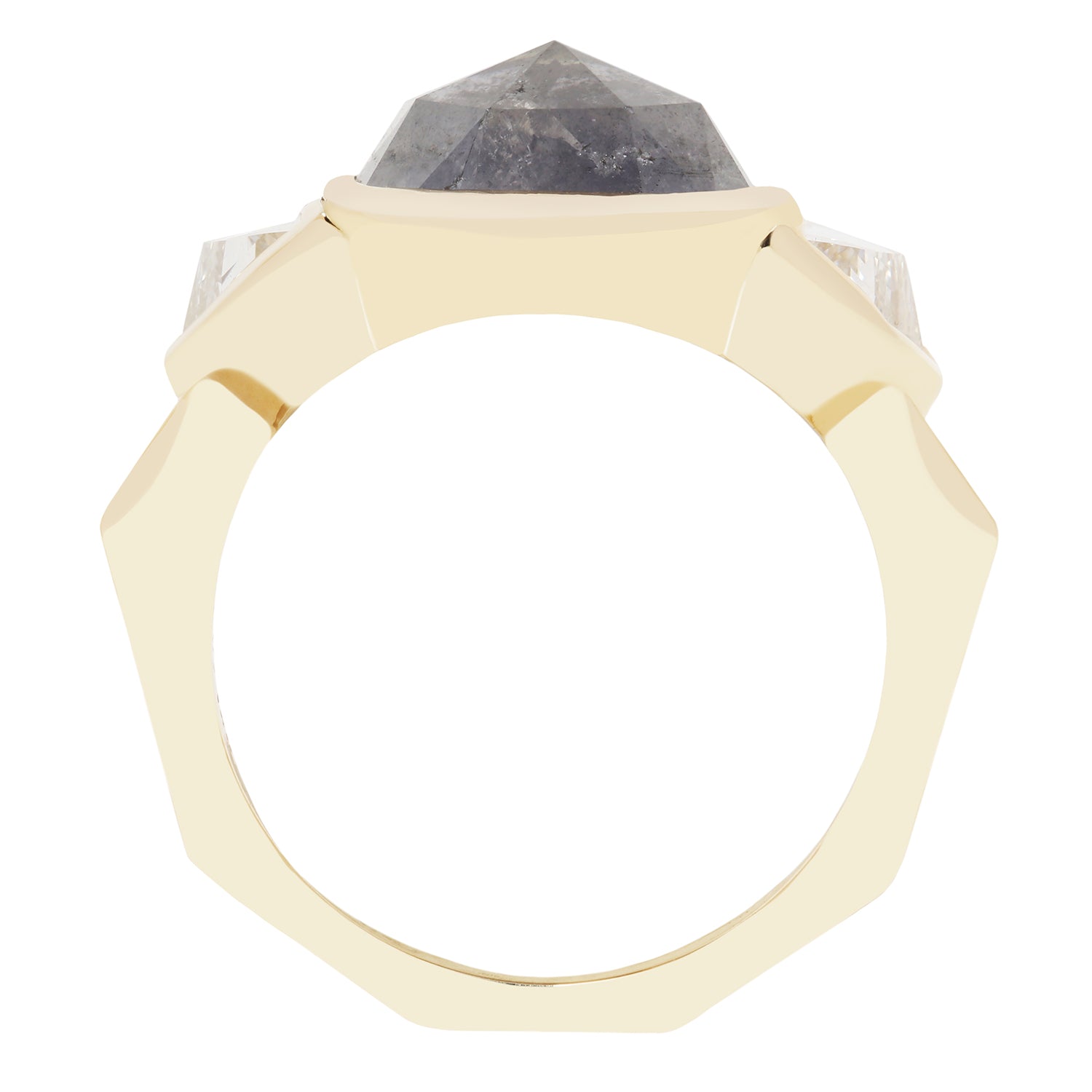 A geometric octagonal ring featuring a faceted dark gray diamond stone in a gold setting, flanked by two clear round-cut stones on a plain white background.