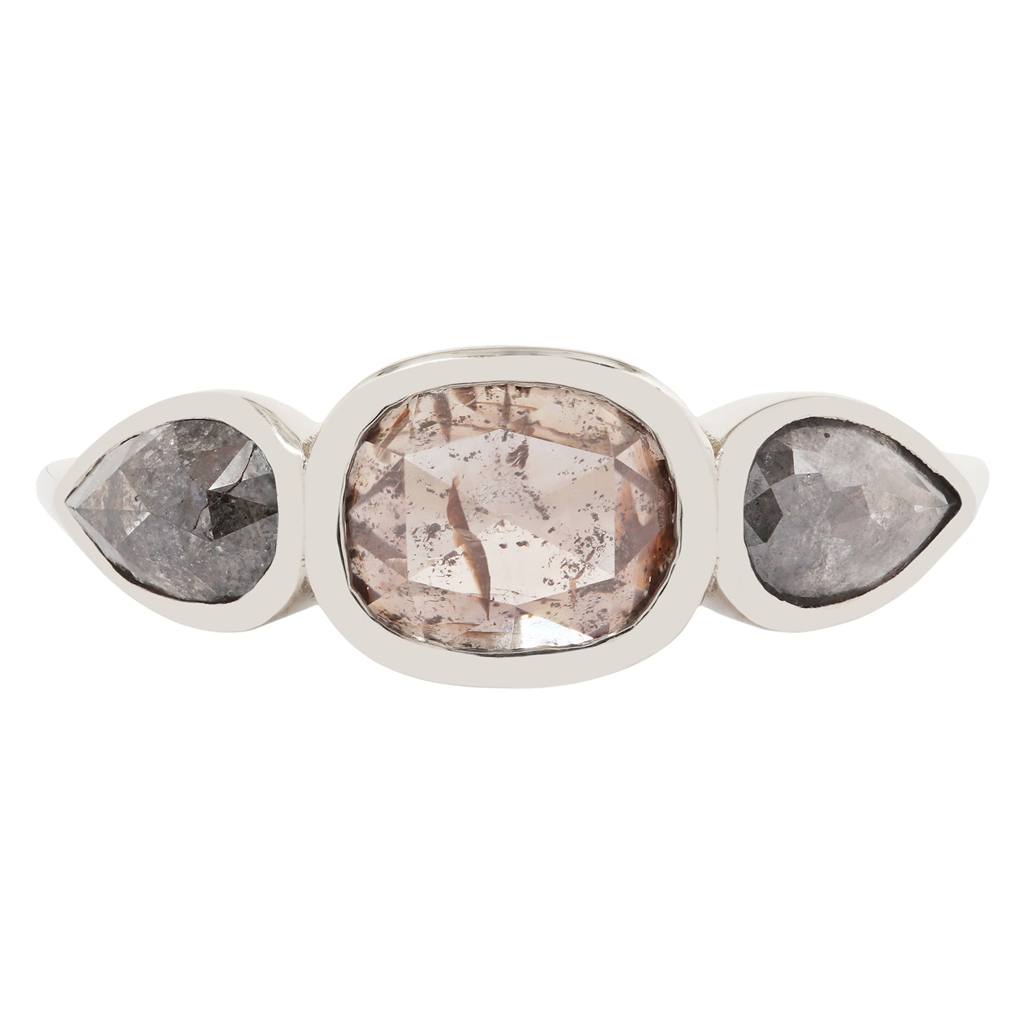 White gold ring with three pear-shaped gemstones on a white background