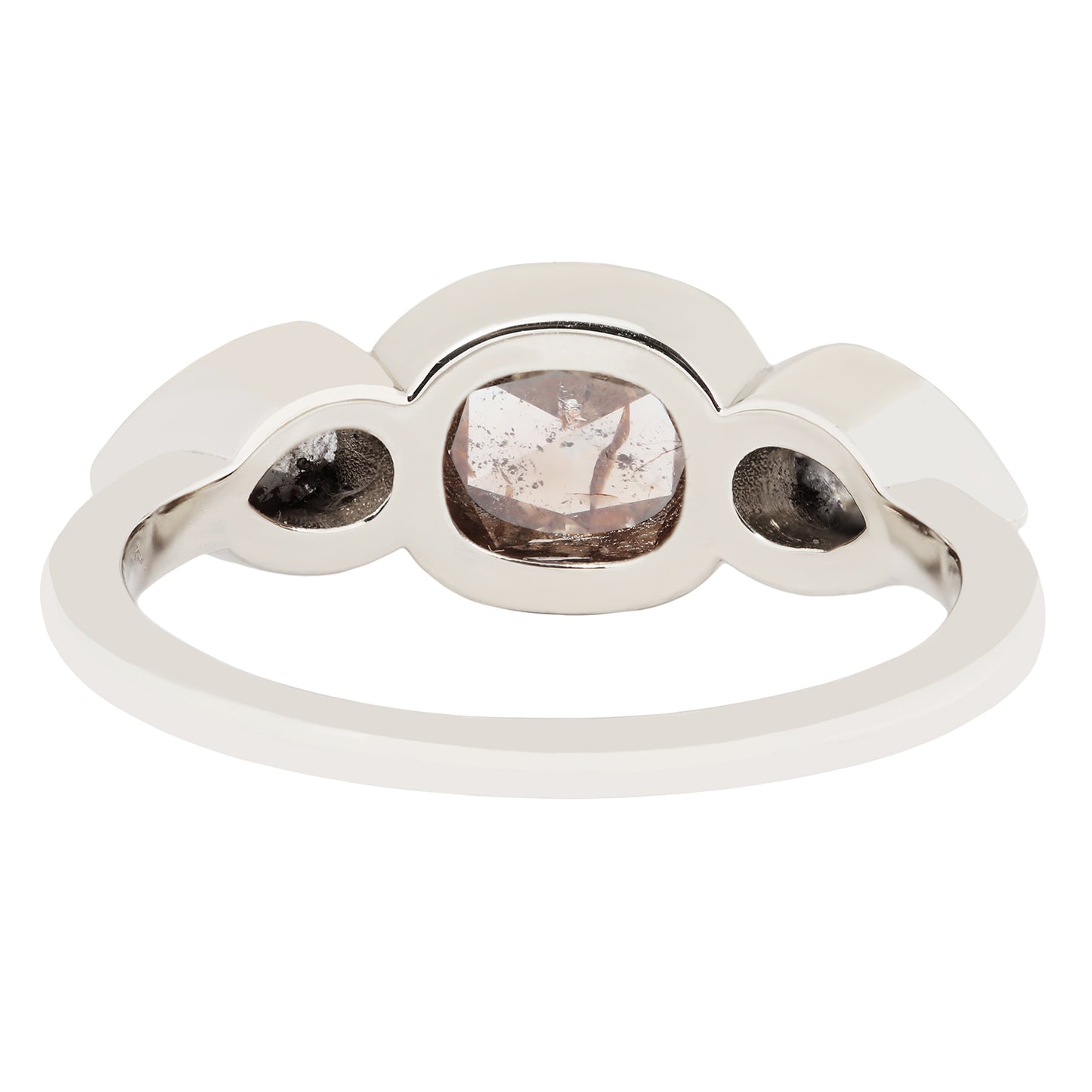 White gold ring with three round gemstones on a white background