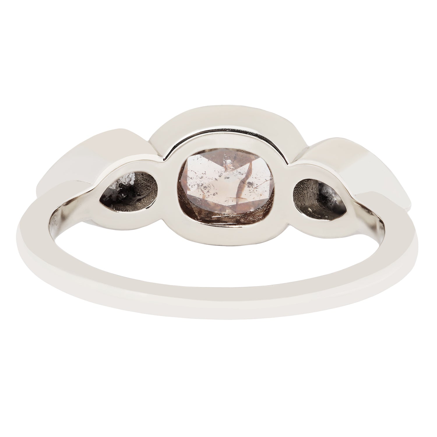 White gold ring with three round gemstones on a white background