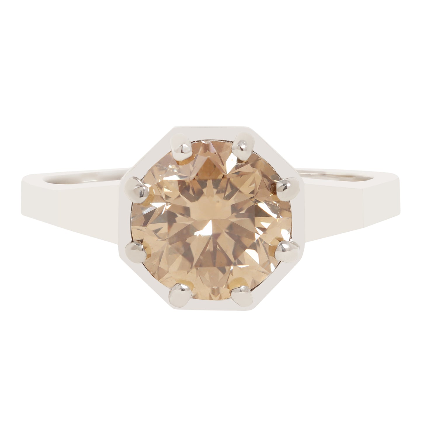 An octagonal solitaire ring featuring a large, round-cut champagne-colored gemstone in a white metal setting with prong holds, shown against a plain white background.