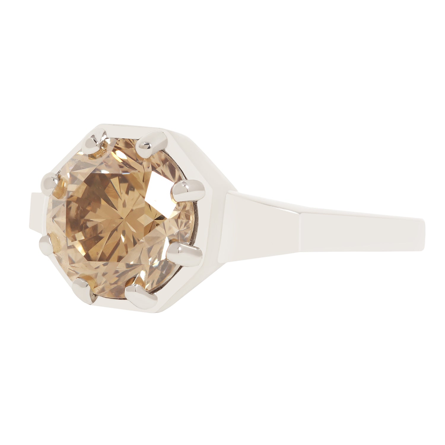 A white gold ring featuring a large, faceted champagne-colored gemstone in a prong setting, shown against a solid white background.
