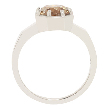 A white gold ring with a large, round, faceted champagne-colored gemstone in a prong setting, shown against a plain white background.