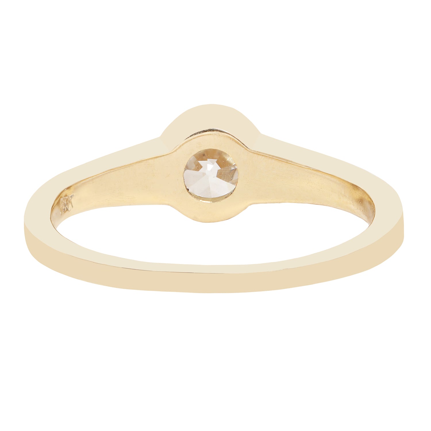 A minimalist yellow gold ring featuring a bezel-set round-cut clear diamond, presented on a solid white background.