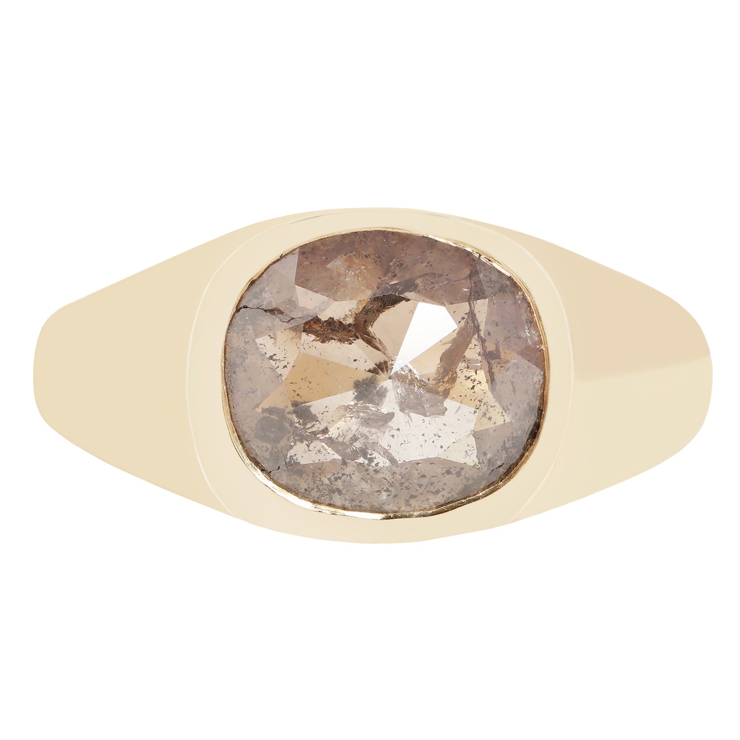 A signet-style ring with a wide, smooth champagne-gold band and a large, cushion-cut rough diamond center stone showing brown, gray, and white crystalline inclusions.