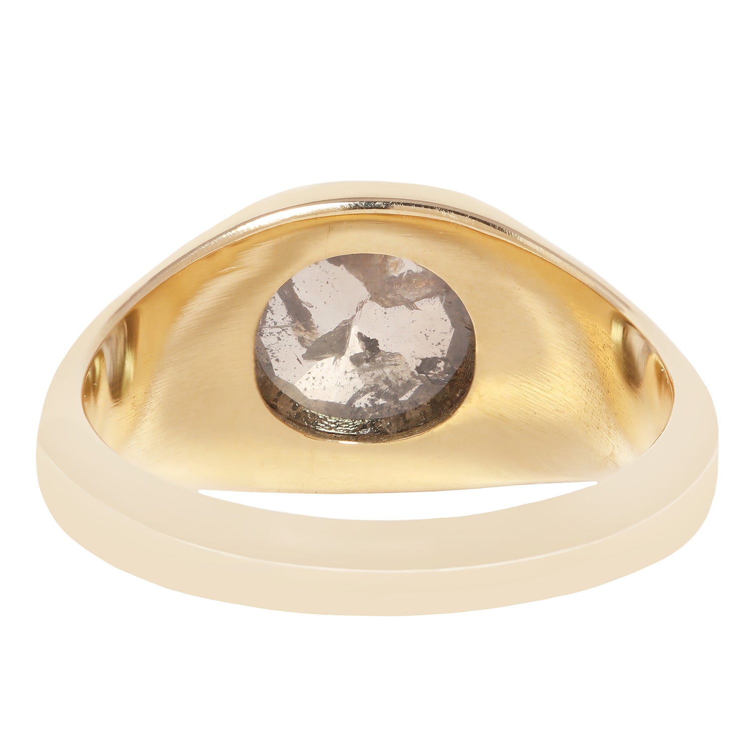 A signet-style ring with a wide, smooth champagne-gold band and a large, cushion-cut rough diamond center stone showing brown, gray, and white crystalline inclusions.