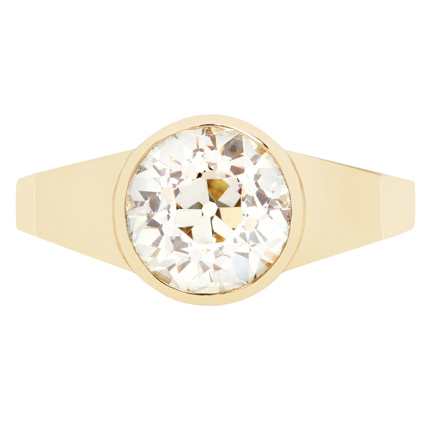 Gold ring with a large diamond on a white background