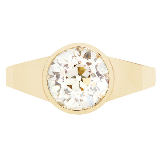 Gold ring with a large diamond on a white background