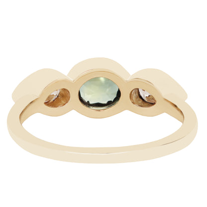 A gold ring with a scalloped top featuring a central round pale green gemstone and two smaller marquise-cut brown gemstones on either side, shown on a plain white background.