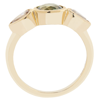 A yellow gold ring featuring a large oval-cut olive green gemstone in the center, flanked by two smaller round-cut clear gemstones in a three-stone setting, shown on a plain white background.
