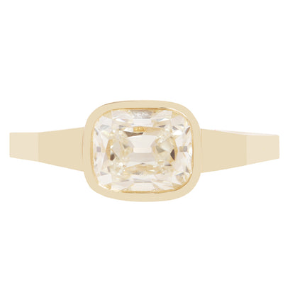 A gold ring with a square bezel-set clear diamond 