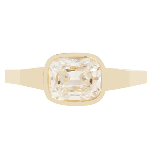 A gold ring with a square bezel-set clear diamond 