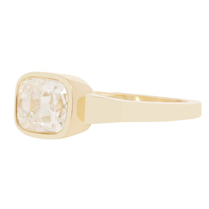 A gold ring with a square bezel-set clear diamond 