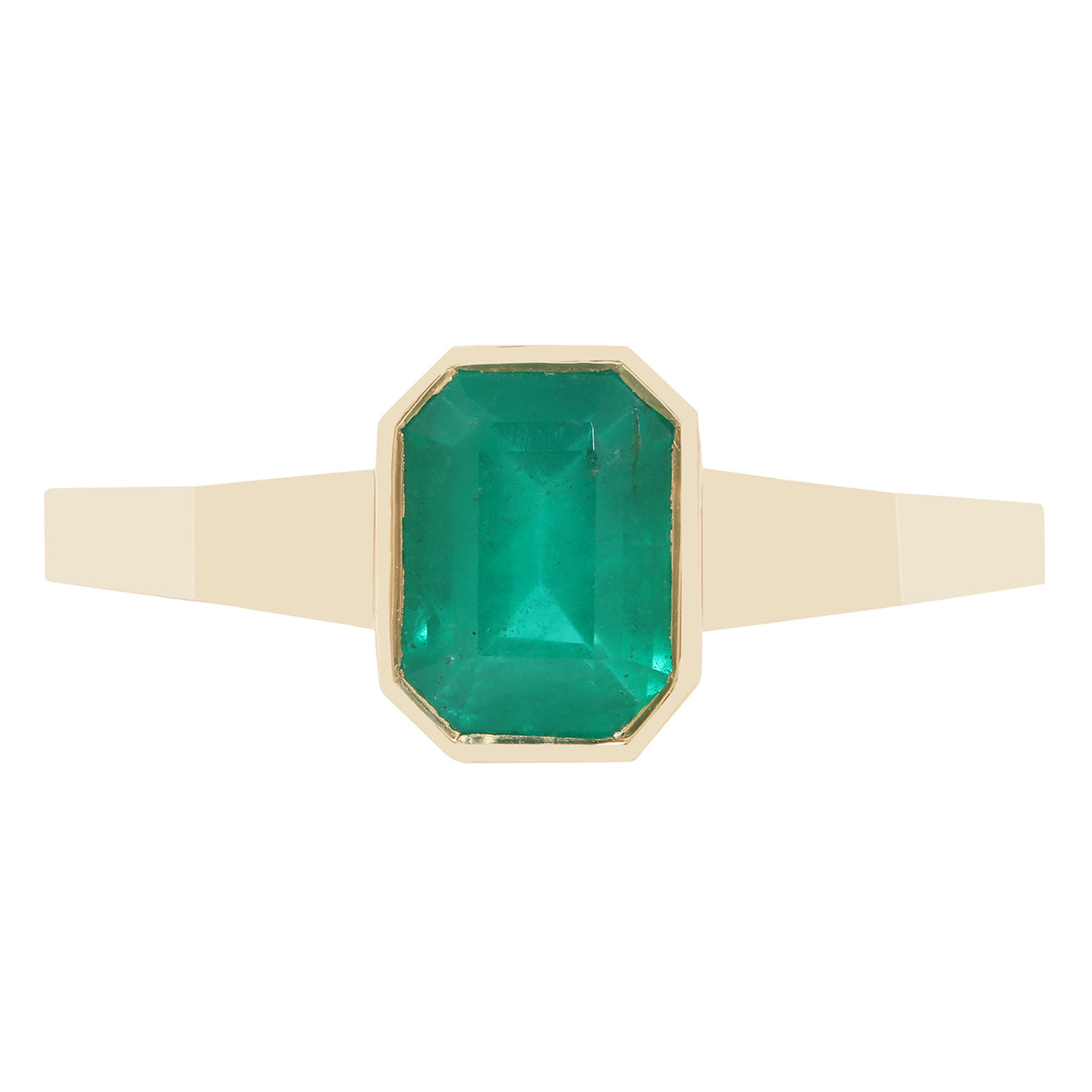 A close-up of a gold ring with a rectangular green gemstone, set against a plain white background.