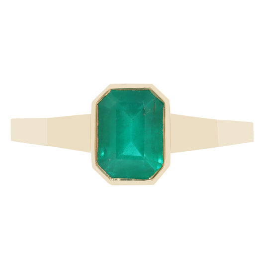 A close-up of a gold ring with a rectangular green gemstone, set against a plain white background.