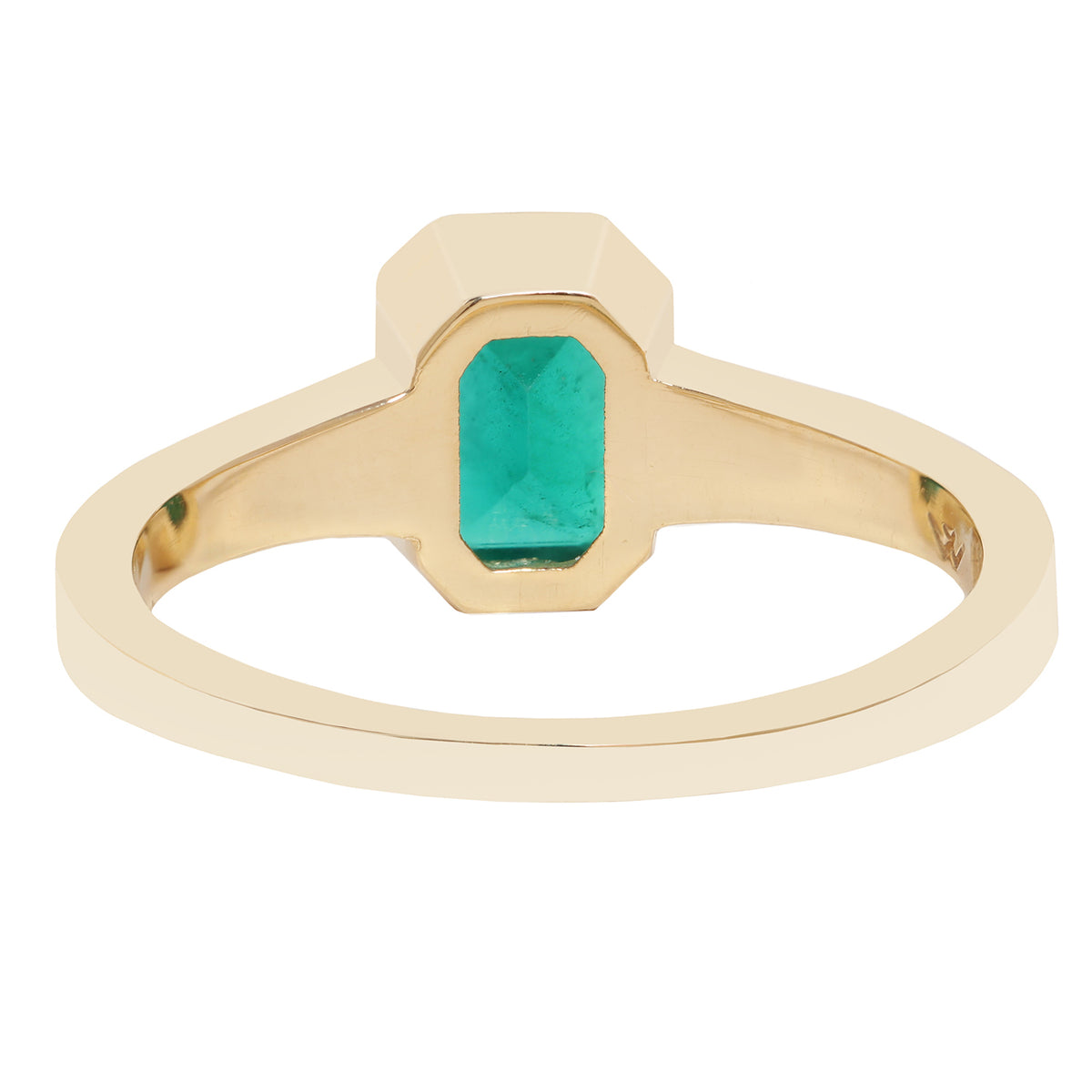 A close-up of a gold ring with a rectangular green gemstone, set against a plain white background.