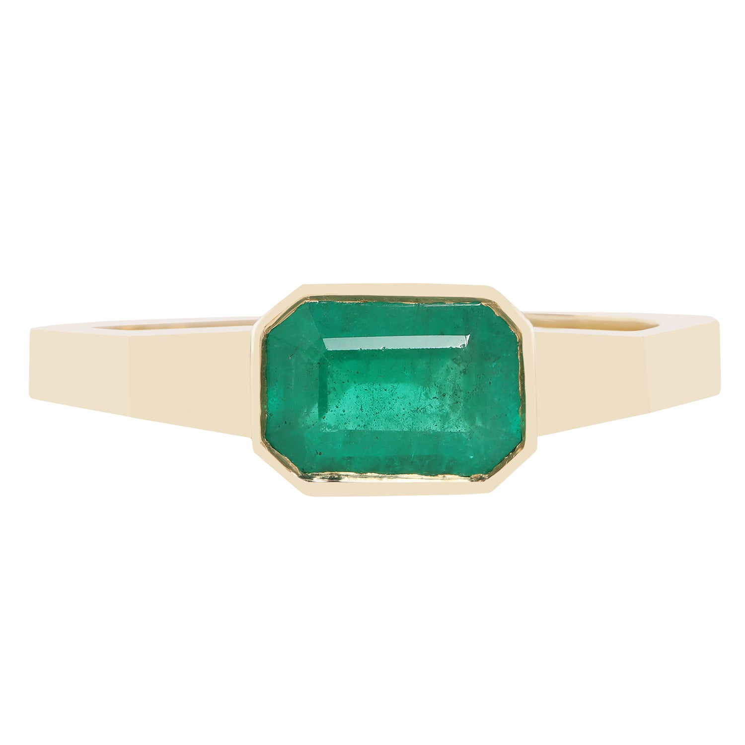 A yellow gold ring featuring a rectangular emerald-cut green gemstone in a bezel setting, shown against a plain white background.