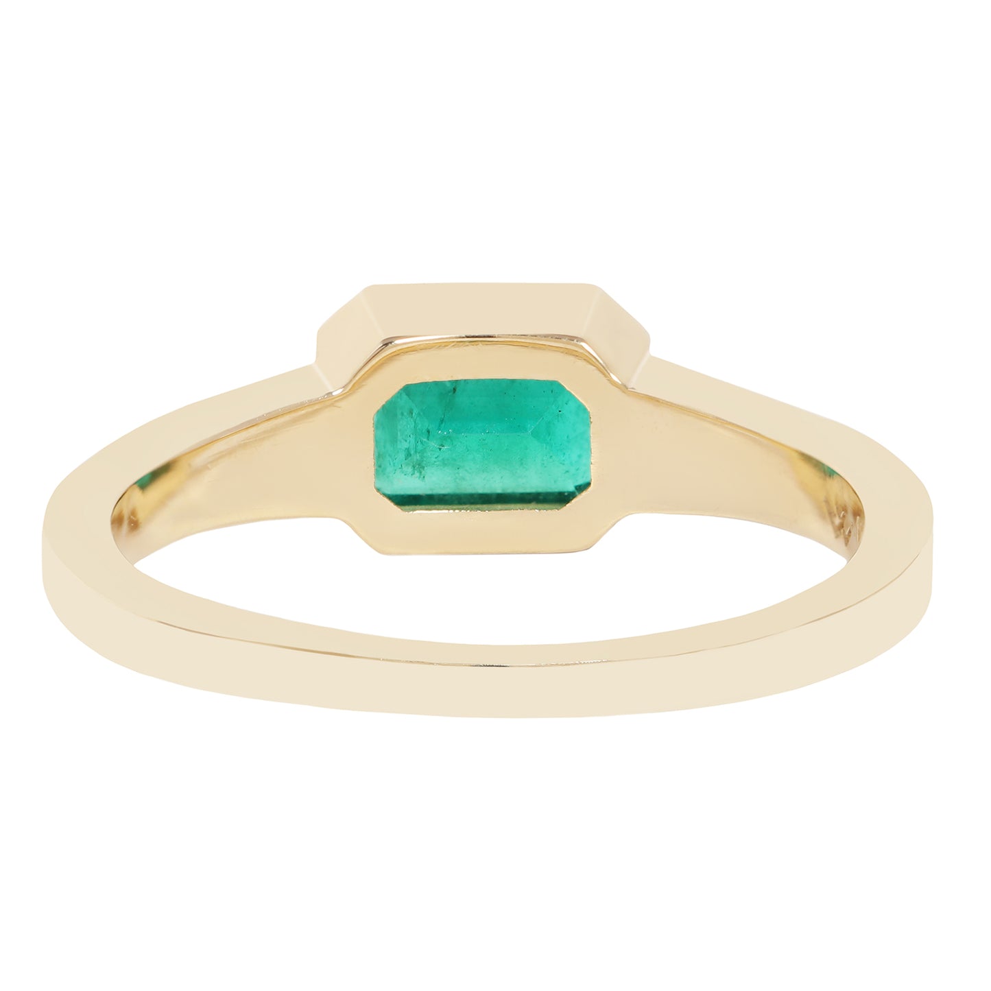 A yellow gold ring featuring a large, faceted emerald-cut green gemstone in a bezel setting, shown against a plain white background.