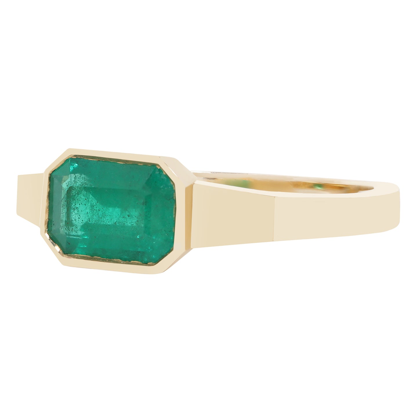 A yellow gold ring featuring a large, faceted emerald-cut green gemstone in a bezel setting, shown against a plain white background.