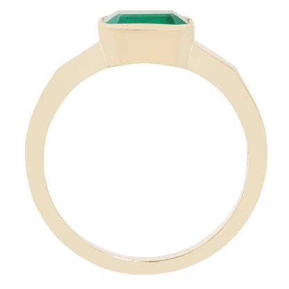 A yellow gold ring featuring a rectangular green gemstone in a bezel setting, shown against a plain white background.