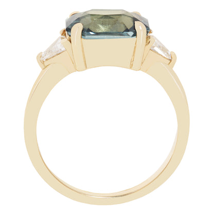 A yellow gold ring featuring a large rectangular-cut blue-green center stone and two small clear accent stones on the shoulders, shown against a plain white background.