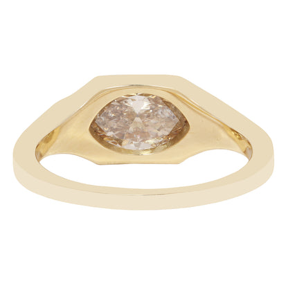 A gold ring featuring a large, irregularly shaped rose-cut diamond center stone, shown on a plain white background.
