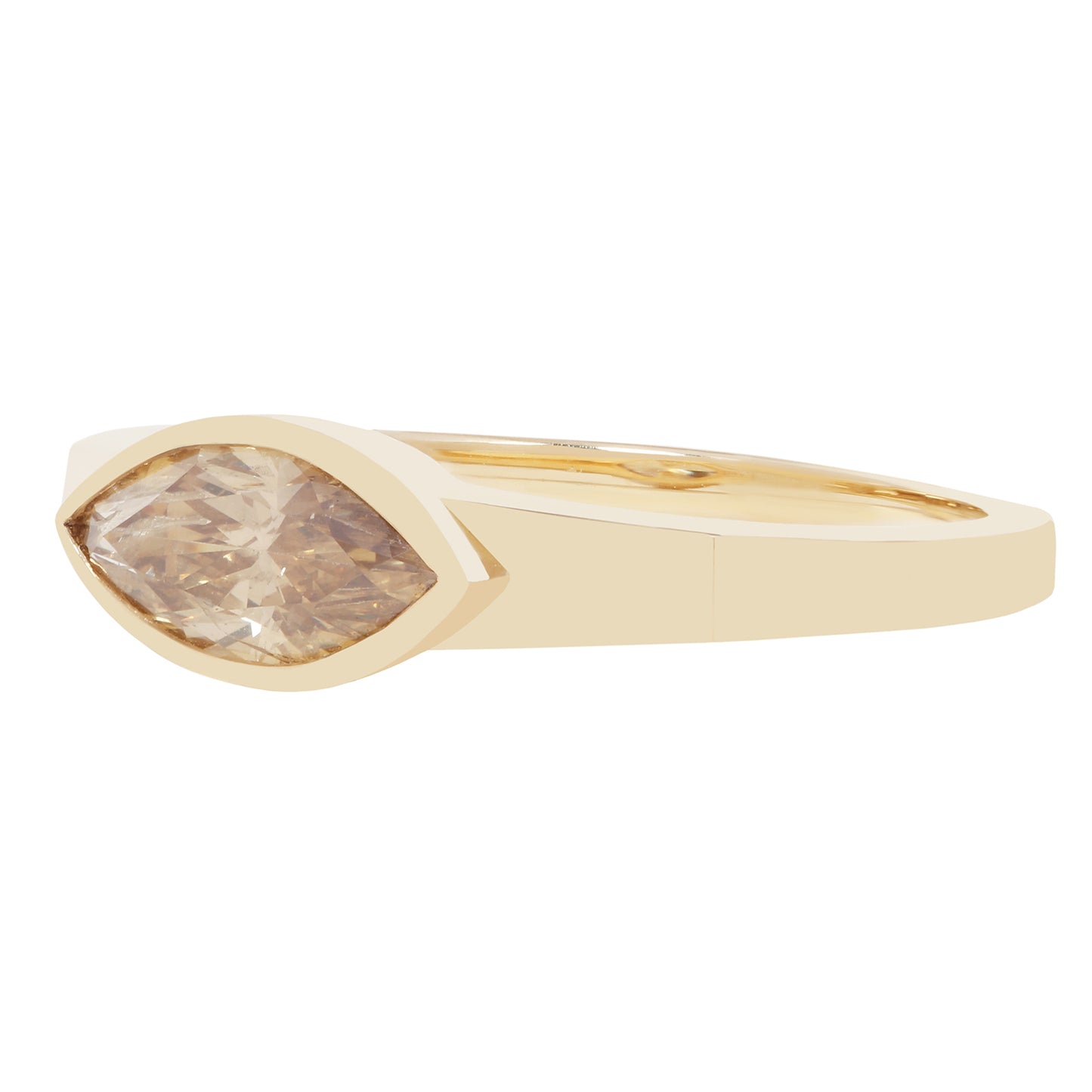 A yellow gold ring featuring a marquise-cut clear gemstone in a bezel setting, shown against a plain white background.