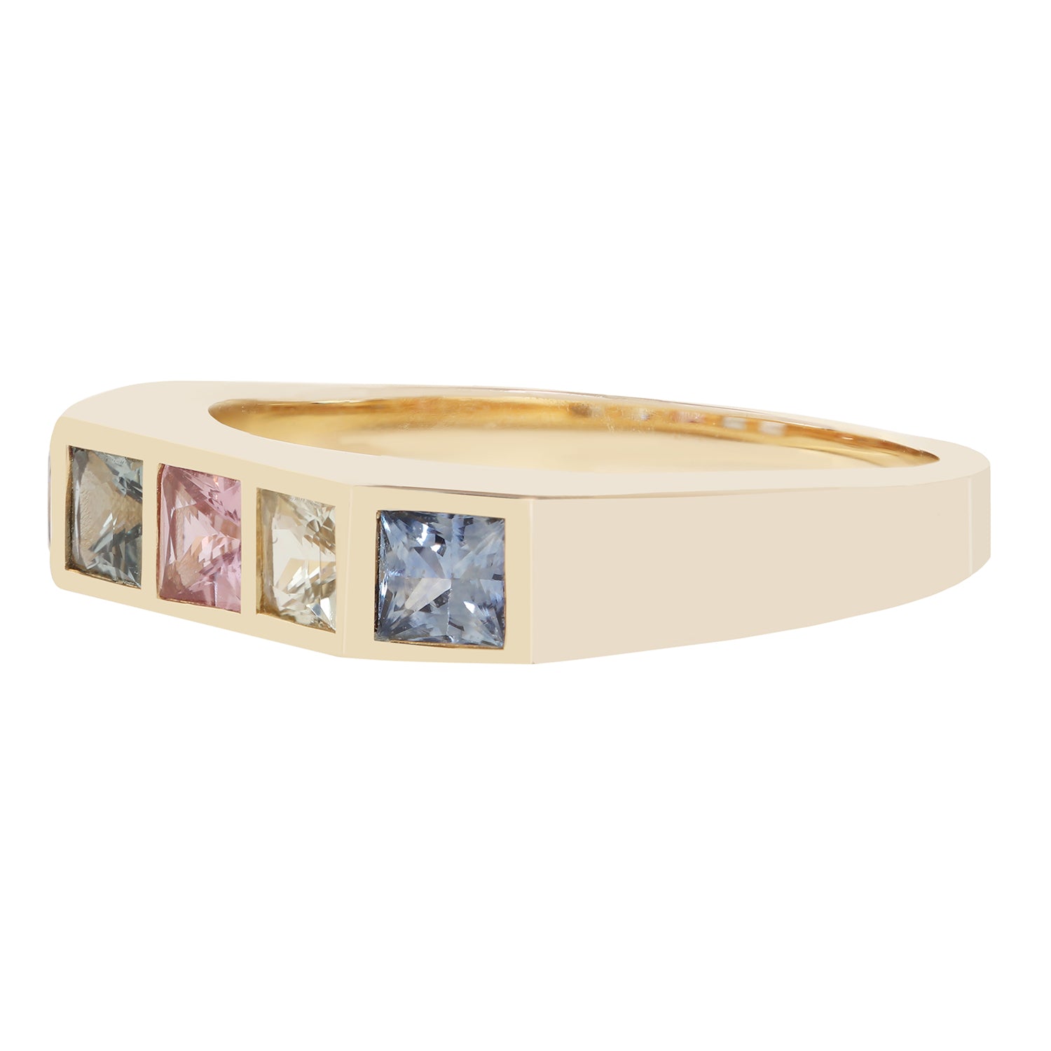 A yellow gold ring featuring four square-cut gemstones in a row, set in a polished bezel. The stones are colored gray, pink, clear, and light blue.