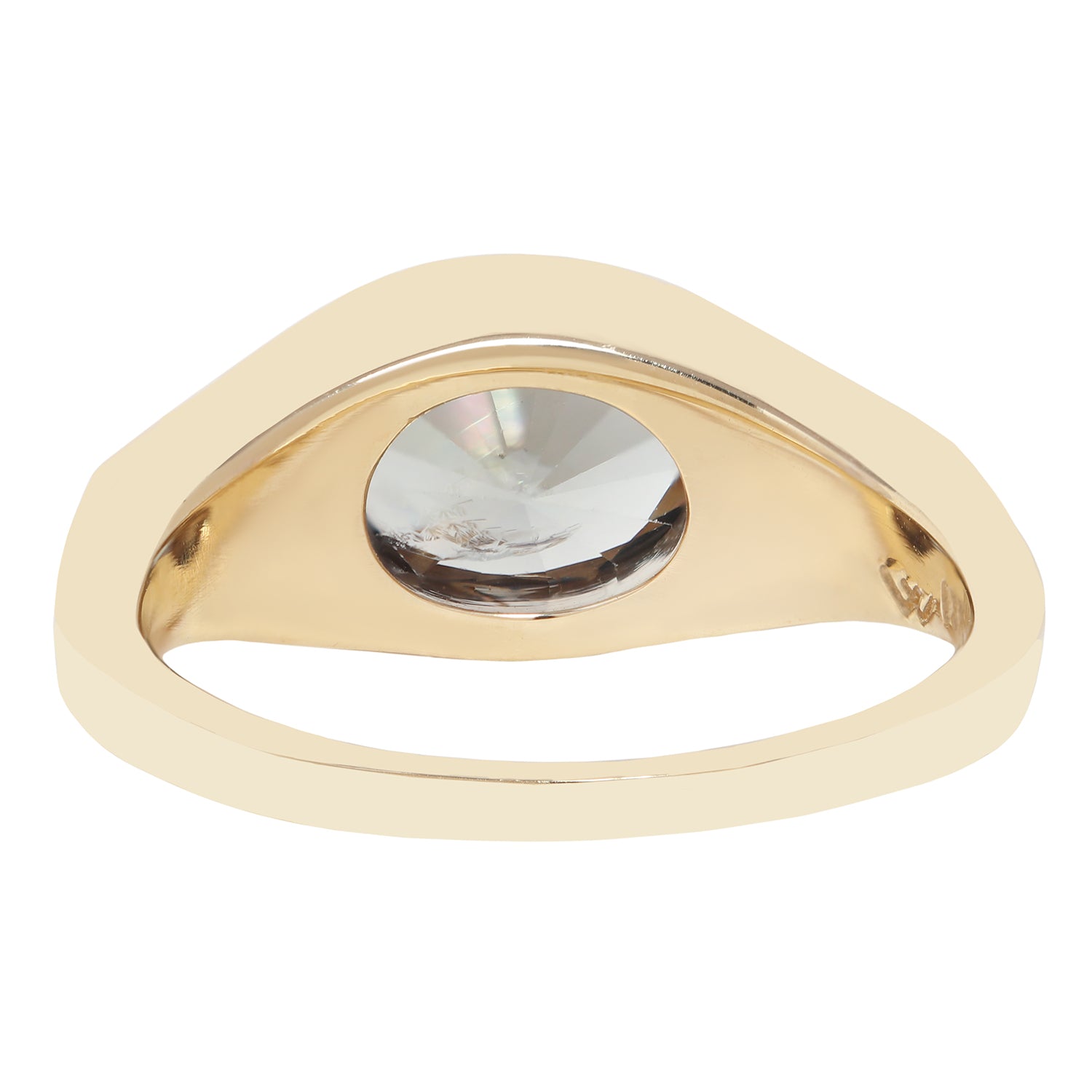 A gold signet-style ring with a large, bezel-set clear faceted gemstone on a plain white background.