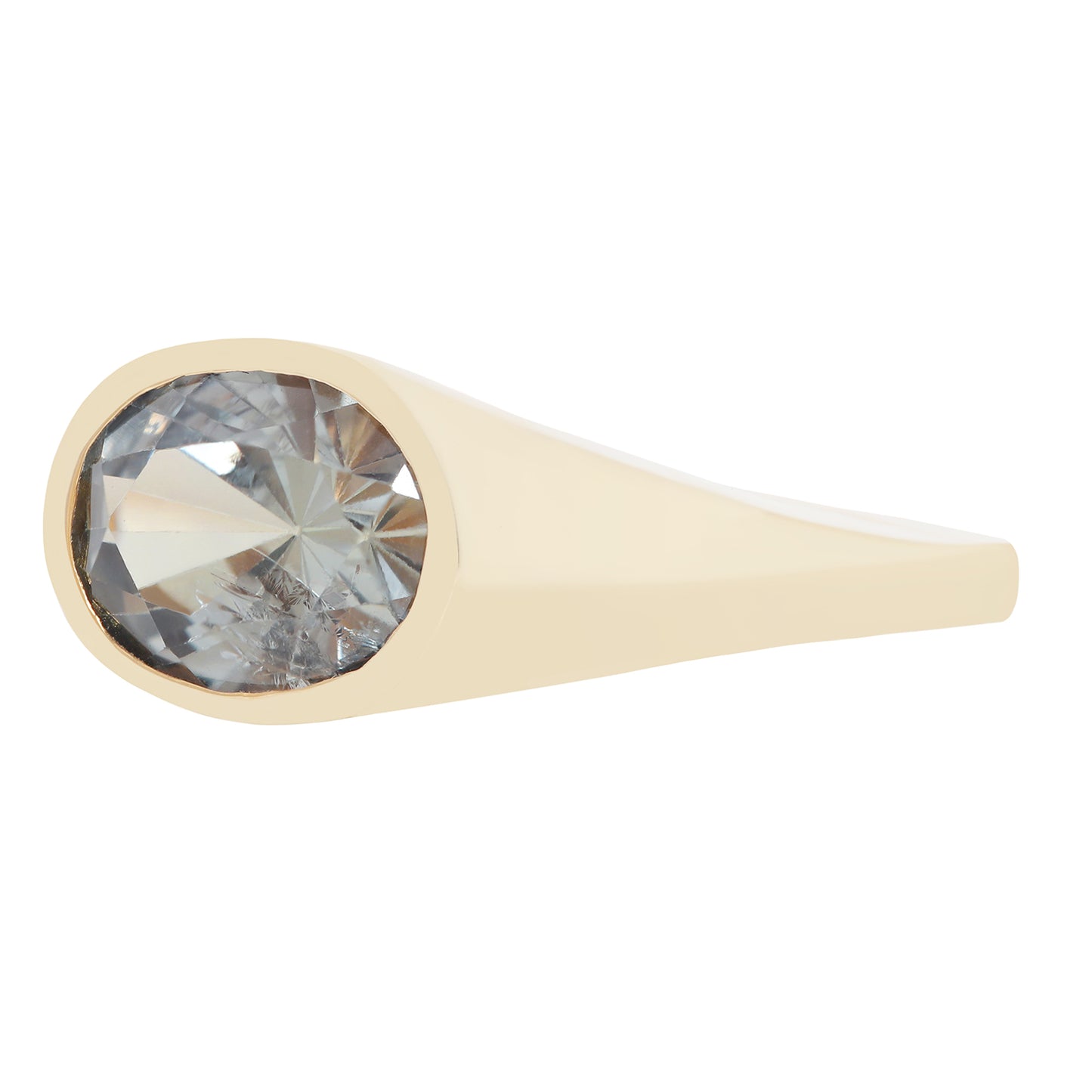 A gold ring featuring a large, round-cut clear gemstone in a bezel setting, shown against a plain white background.