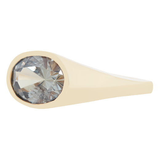 A gold ring featuring a large, round-cut clear gemstone in a bezel setting, shown against a plain white background.