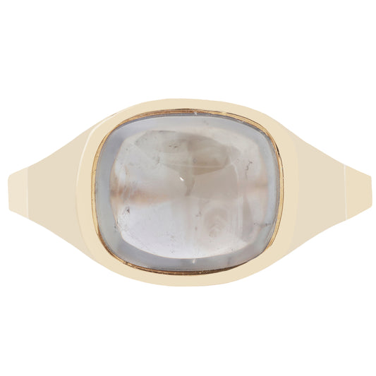 A gold signet ring featuring a large, cushion-cut pale gray stone with visible inclusions, set against a plain white background.