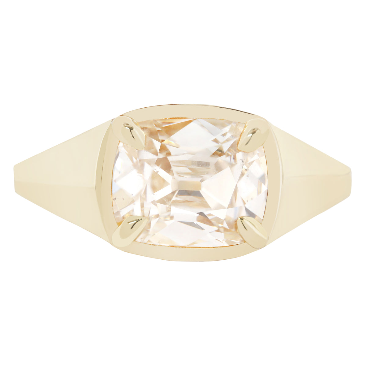 A cushion-cut clear diamond ring set in a yellow gold bezel with a wide flat band, shown against a plain white background.
